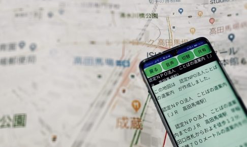 実際の地図の上に、ことばの道案内を開いたスマホを写している画像